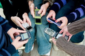 Several teenagers texting each other